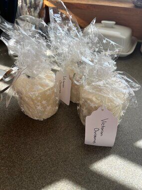 Three white candles, all dressed up